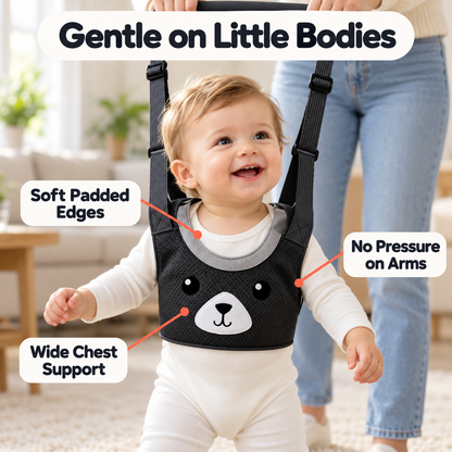 Smiling baby wearing a soft padded black walking harness with wide chest support